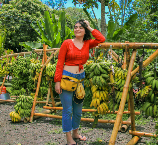 black woman hold hair with bananas  